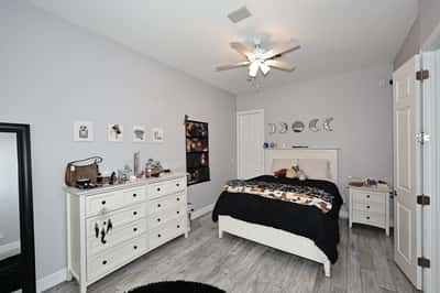 Comfortable guest bedroom featuring updated flooring, ceiling fan, and neutral finishes ideal for Scottsdale living and hosting visitors.