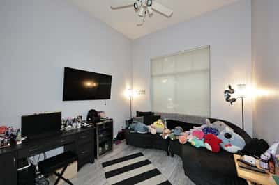 Flexible room with workspace setup, natural light, and modern flooring perfect for a Scottsdale office, bedroom, or hobby room.
