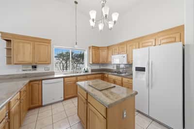 Updated kitchen showcases newer appliances, extensive cabinet storage, and generous counter space designed for both entertaining and everyday convenience.