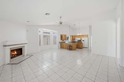 Open kitchen and living spaces with soaring ceilings and tile flooring create an airy, functional layout ideal for entertaining and everyday Arizona living.