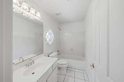 Bright guest bathroom with clean finishes, full shower and tub combination, and spacious vanity adds comfort and convenience for family and visitors.