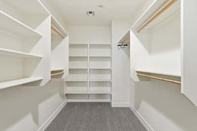 Generously sized walk-in closet with custom shelving and multiple storage options. Perfect for organizing clothing, accessories, and seasonal items.