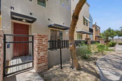 Gated front patio with attractive brick accents and mature landscaping creates a welcoming first impression. An ideal outdoor space for enjoying Arizona's beautiful weather.