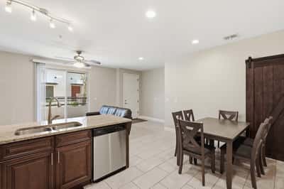 Open living and dining space with tile flooring, recessed lighting, and direct access to the kitchen. The versatile layout supports entertaining, relaxing, and working from home.