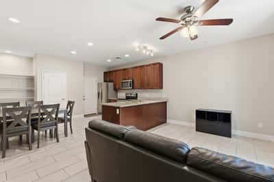 Open living area connected to the kitchen and dining space for effortless entertaining. Recessed lighting and modern finishes create a bright and functional environment.