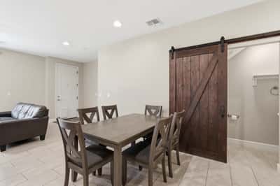Dedicated dining area featuring stylish finishes and a decorative barn door accent. Perfect for everyday meals, holiday gatherings, and entertaining guests.