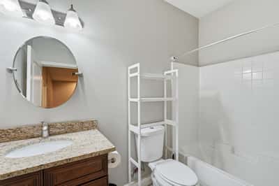 Full bathroom featuring granite countertops, updated cabinetry, and a tub/shower combination. A clean, functional space that complements the home's move-in-ready appeal.