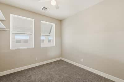 Spacious secondary bedroom with soft carpeting, neutral finishes, and natural light. A flexible room well-suited for guests, remote work, hobbies, or everyday living needs.