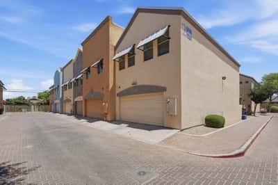 Exterior view highlighting modern townhome architecture, attached garages, and attractive community design. The well-kept setting contributes to the property's move-in-ready appeal.
