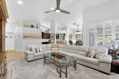 Designed for both comfort and entertaining, this spacious great room features soaring ceilings, neutral finishes, and excellent natural light. The versatile layout accommodates a variety of furniture arrangements.