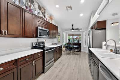 Updated cabinetry, stainless steel appliances, and expansive countertops make this kitchen both functional and stylish. The efficient layout provides excellent workflow for cooking and entertaining.