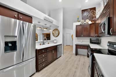Featuring upgraded cabinetry, solid surface countertops, and stainless steel appliances, this kitchen is designed for both efficiency and style. The open floor plan keeps the space connected to surrounding living areas.