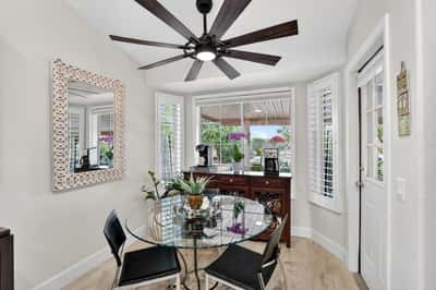 Surrounded by windows and overlooking the backyard, this breakfast nook creates the perfect setting for daily meals. Plantation shutters and updated flooring add style and practicality.
