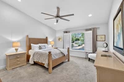 This spacious owner's suite offers a peaceful atmosphere with large windows, soft carpeting, and abundant natural light. The comfortable layout makes it easy to create your perfect private retreat.