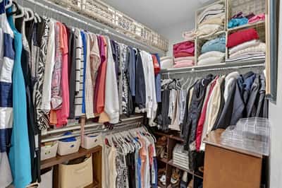 Enjoy exceptional storage in this walk-in closet complete with built-in shelving, hanging areas, and organized compartments. Designed to keep wardrobes and accessories neatly arranged.