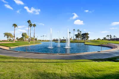 Decorative fountains, sparkling water, and manicured golf course landscapes create a stunning community focal point. This scenic setting enhances the overall appeal of the Goodyear lifestyle.