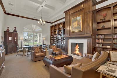 Featuring a fireplace, custom built-ins, and inviting seating, this community library offers a comfortable place to read, work, or connect with neighbors.