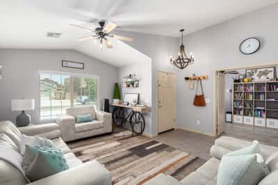 Filled with natural light and enhanced by vaulted ceilings, this spacious great room offers flexible living space that flows effortlessly into the dining area, making it perfect for entertaining.