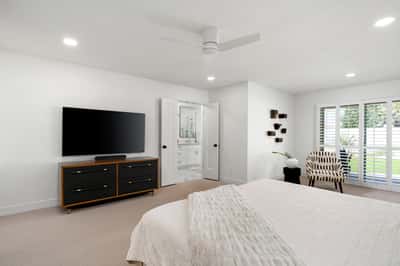 Enjoy a spacious owner's retreat complete with elegant finishes, abundant natural light, plantation shutters, and direct access to a beautifully updated ensuite bath, creating a luxurious private escape.