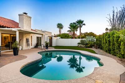 Enjoy peaceful mornings and unforgettable evenings beside the sparkling pool, framed by mature landscaping and scenic mountain views. This outdoor retreat perfectly complements the home's indoor living spaces.
