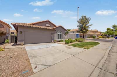 Large driveway leading to an attached two-car garage complete with built-in storage cabinets and a garage door opener. Functional parking and storage make everyday living even more convenient.