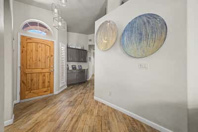 Open-concept living room with vaulted ceilings, abundant natural light, and easy access to the outdoor living space. Perfect for entertaining family and friends or relaxing at home.