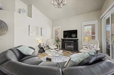 Elegant great room with vaulted ceilings, designer lighting, a beautiful fireplace, and sliding doors leading to the covered patio. This inviting space is ideal for enjoying Arizona's indoor-outdoor lifestyle.