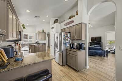 Spacious kitchen with granite countertops, stainless steel appliances, breakfast bar seating, and an open flow into the living area. Designed to accommodate both everyday living and entertaining.