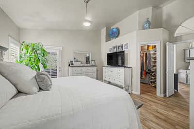 Spacious owner's suite featuring a walk-in closet, high ceilings, stylish flooring, and a private ensuite bathroom. Designed to provide comfort, storage, and everyday convenience.