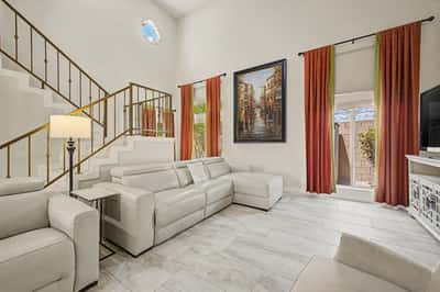 The dramatic great room showcases soaring ceilings, updated tile flooring, oversized windows, and a spacious open design ideal for entertaining and everyday living in this beautifully updated Scottsdale home.