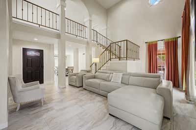 The spacious main living area combines soaring ceilings, classic architectural details, and a flowing floor plan with abundant natural light to create an inviting space perfect for relaxing or entertaining.