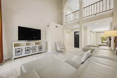 Enjoy a bright and open great room with updated flooring, soaring ceilings, and generous space for entertaining. Large windows enhance the home's airy feel while connecting the indoor and outdoor living areas.