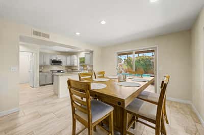 This spacious dining area connects effortlessly to the updated kitchen, creating a welcoming environment for gatherings. Natural light, backyard views, and an open floor plan make entertaining easy.