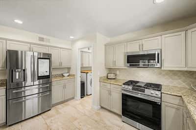 Updated cabinetry, granite countertops, stainless steel appliances, and recessed lighting combine to create a stylish kitchen that's both functional and inviting. A perfect gathering space for everyday living.