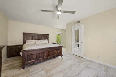 Relax in this oversized primary suite featuring updated tile flooring, contemporary ceiling fan, neutral finishes, and generous space for large furnishings. A peaceful retreat designed for comfortable Scottsdale living.