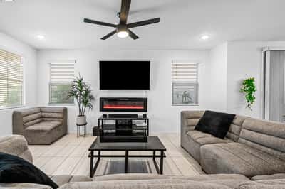 Spacious great room with abundant natural light, modern flooring, recessed lighting, and an electric fireplace. Designed for comfortable everyday living and effortless entertaining.