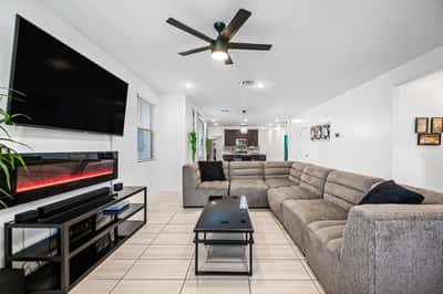 Another view of the spacious great room highlighting the open floor plan, stylish finishes, modern lighting, and easy flow throughout the home's main living areas.