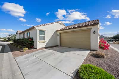 Attached two-car garage with spacious driveway parking and well-maintained exterior. Adds convenience and complements the attractive curb appeal of this Goodyear home.