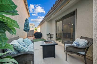 Comfortable outdoor patio with cozy seating, a fire feature, and private surroundings. Ideal for morning coffee, evening gatherings, or enjoying Arizona's outdoor lifestyle in Goodyear.