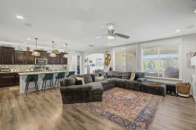 Expansive great room seamlessly connects to the gourmet kitchen, creating an ideal setting for entertaining with stylish finishes, abundant natural light, and comfortable gathering spaces.
