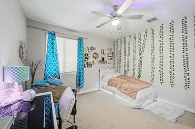 Inviting secondary bedroom offers generous dimensions, decorative finishes, plush carpeting, and abundant natural light, making it perfect for multiple living needs.