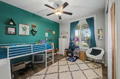 Bright bedroom features upgraded flooring, plantation shutters, contemporary finishes, and a versatile layout ideal for children, guests, or a home office.