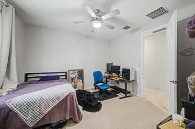 Alternate perspective of the secondary bedroom showcases its open layout, neutral finishes, and comfortable proportions ideal for family members or overnight guests.