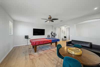 Alternate view of the upstairs bonus room showcases its generous layout, wood-look flooring, and versatile design ideal for gatherings, hobbies, or additional living space.