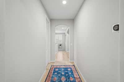 Well-designed upstairs hallway connects the bedrooms and living areas while maintaining an open, bright feel with neutral finishes and quality craftsmanship.