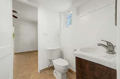 Bathroom vanity area with updated cabinetry, contemporary sink, modern faucet, tile flooring, and natural light. This refreshed bathroom provides both style and functionality within this well-maintained Phoenix property.