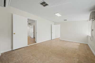 Oversized family room featuring durable tile flooring, bright windows, and an open layout ready for entertaining, recreation, or additional living space. A flexible room that adapts to a variety of needs.