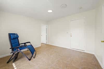 Spacious bonus room with neutral finishes, tile flooring, recessed lighting, and private entrance. Perfect for a home office, guest quarters, recreation room, or additional family living space in this Phoenix property.