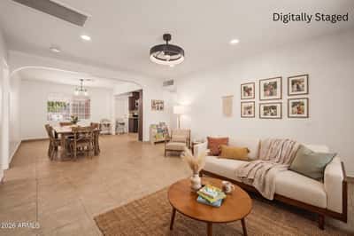 Digitally staged open-concept great room featuring comfortable seating, dining space, and a welcoming layout that helps buyers visualize the home's entertaining potential in Phoenix.