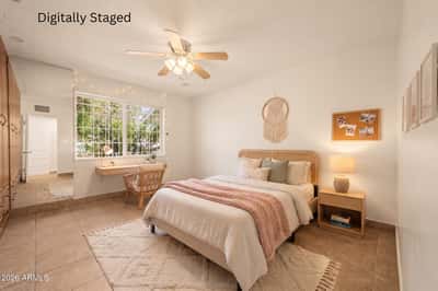 Digitally staged bedroom with warm contemporary furnishings, soft neutral colors, custom built-in cabinetry, and abundant natural light, helping buyers visualize the room's full potential.